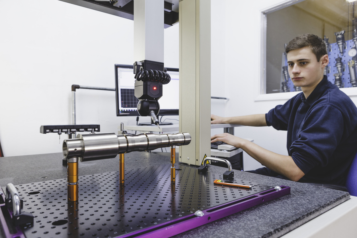 An image of a person using a precision laser tool to measure a piece of rotating machinery.